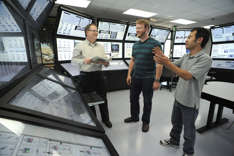 Three men in the Human System Simulation Lab